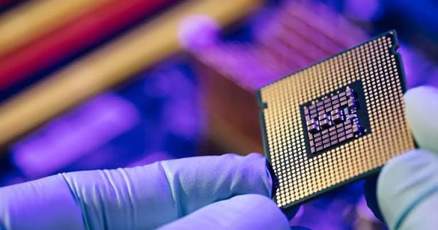 Processor package held between gloved fingers